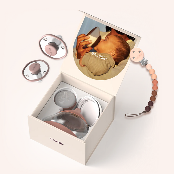 Emulait baby product set with pacifiers and a teether in an open box on a white background.