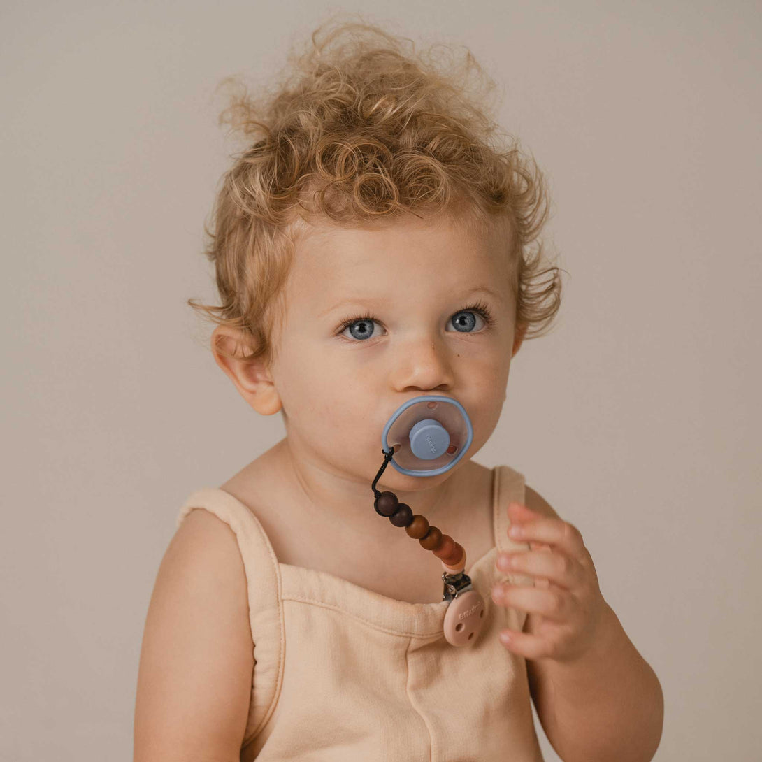 Baby with Blu Emulait Pacifier and Pacifier Clip