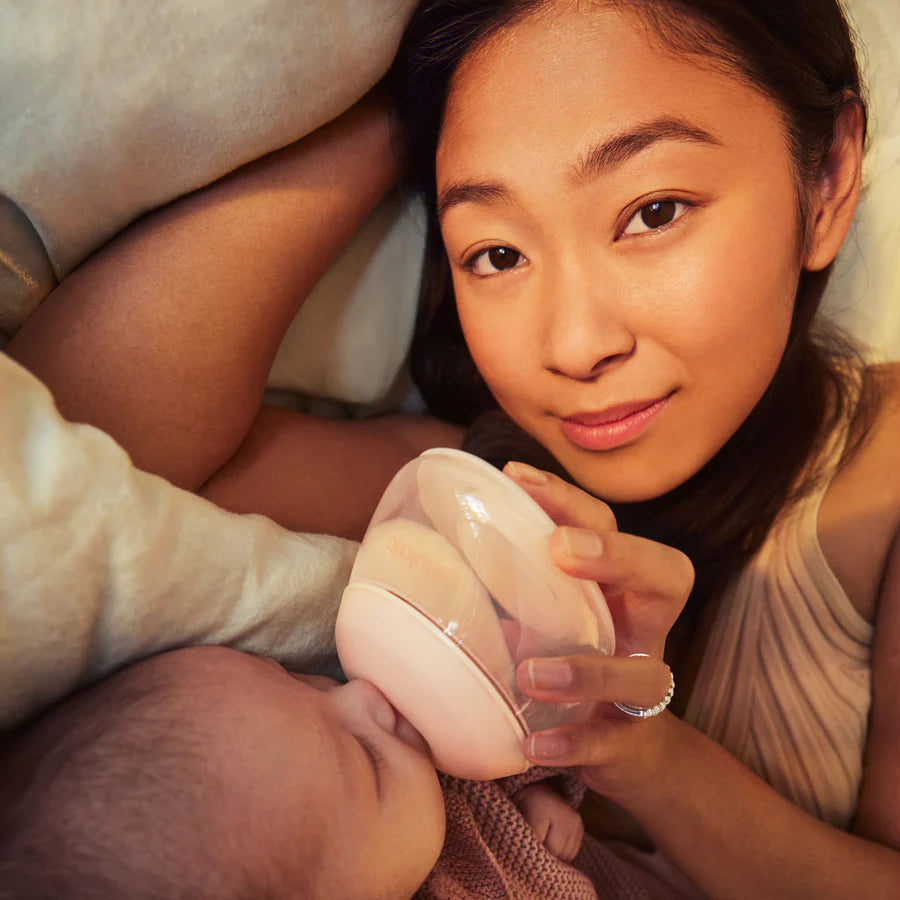 Mother feeding baby with Emulait Anatomy Bottle
